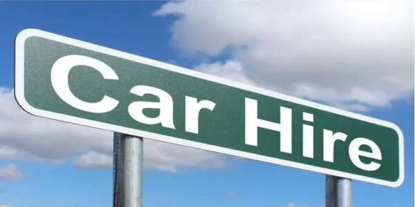 green car hire sign with sky as a backround